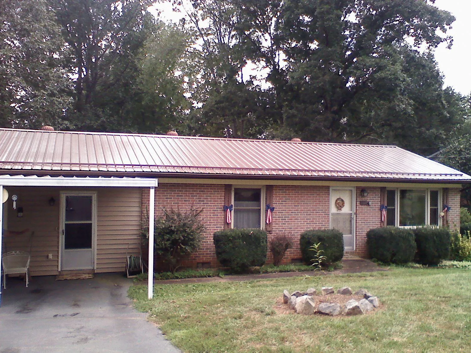 Bronze metal roof and carport on a brick ranch home — Roof Repair work by our crew in Marble Hill